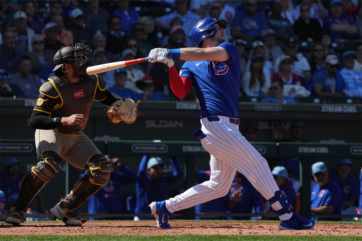 Chicago Cubs outfielder Kyle Tucker (30) hits an RBI sacrifice fly out against the San Diego Padres in the third inning at Sloan Park.