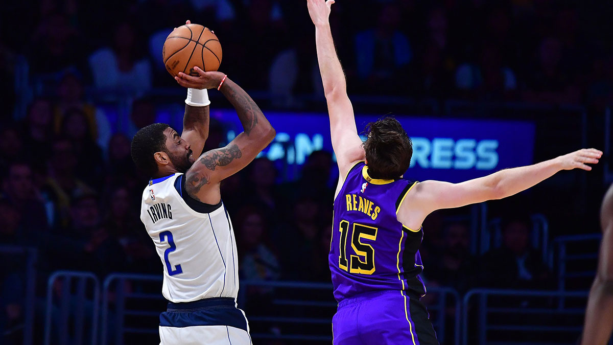 Dallas Mavericks guard Kyrie Irving (2) shoots against Los Angeles Lakers guard Austin Reaves (15) during the second half at Crypto.com Arena. 