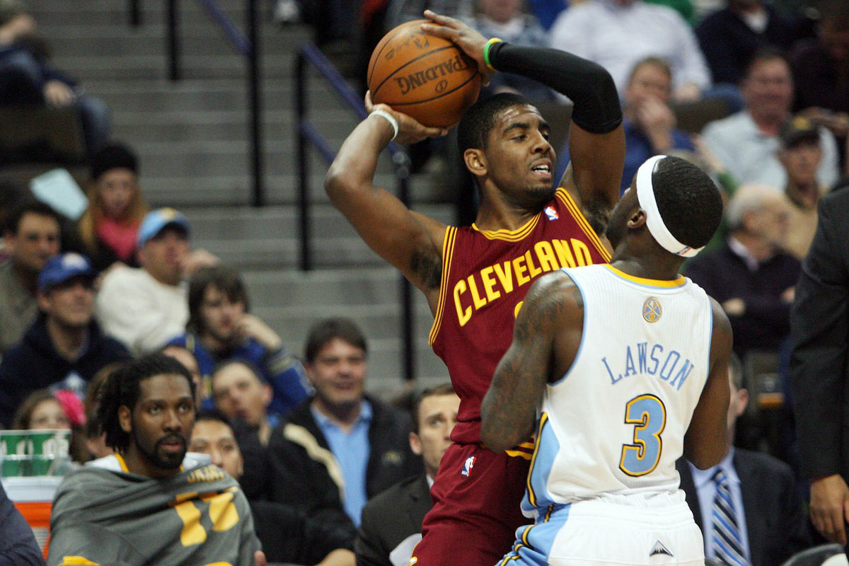 Cleveland Cavilers guard Kyrie Irving (left) is guarded by Denver Nuggets Ty Lawson (3) during the third quarter at the Pepsi Center.