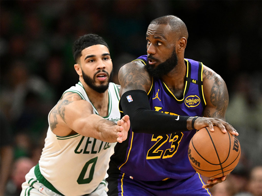 Los Angeles Lakers forward LeBron James (23) controls the ball against Boston Celtics forward Jayson Tatum (0) during the fourth quarter at the TD Garden.