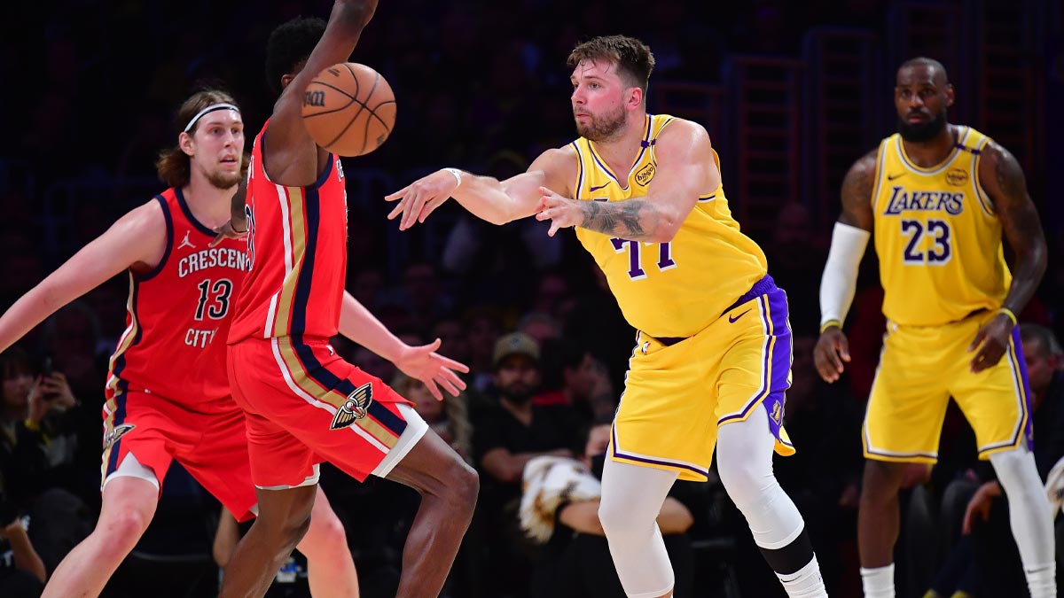 Lakers guard Luka Doncic (77) passes the ball