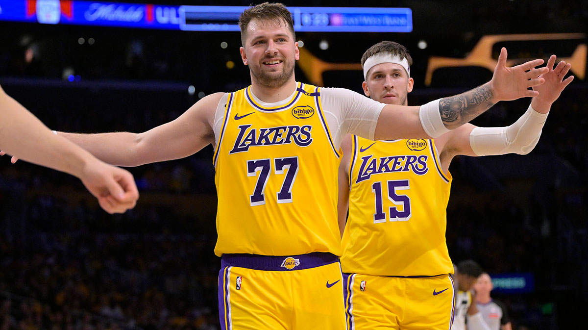 Lakers guard Luka Doncic (77) and Lakers guard Austin Reaves (15) react after a basket against the Utah Jazz at Crypto.com Arena