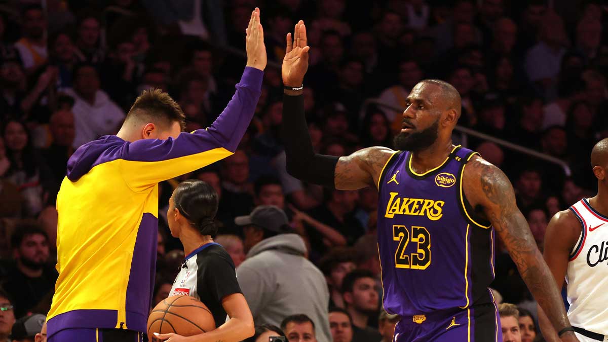 Lakers forward Lebron James (23) celebrates with the Back Luka Doncycic (77) during the second quarter of La Clippers on Cripto.com Arena