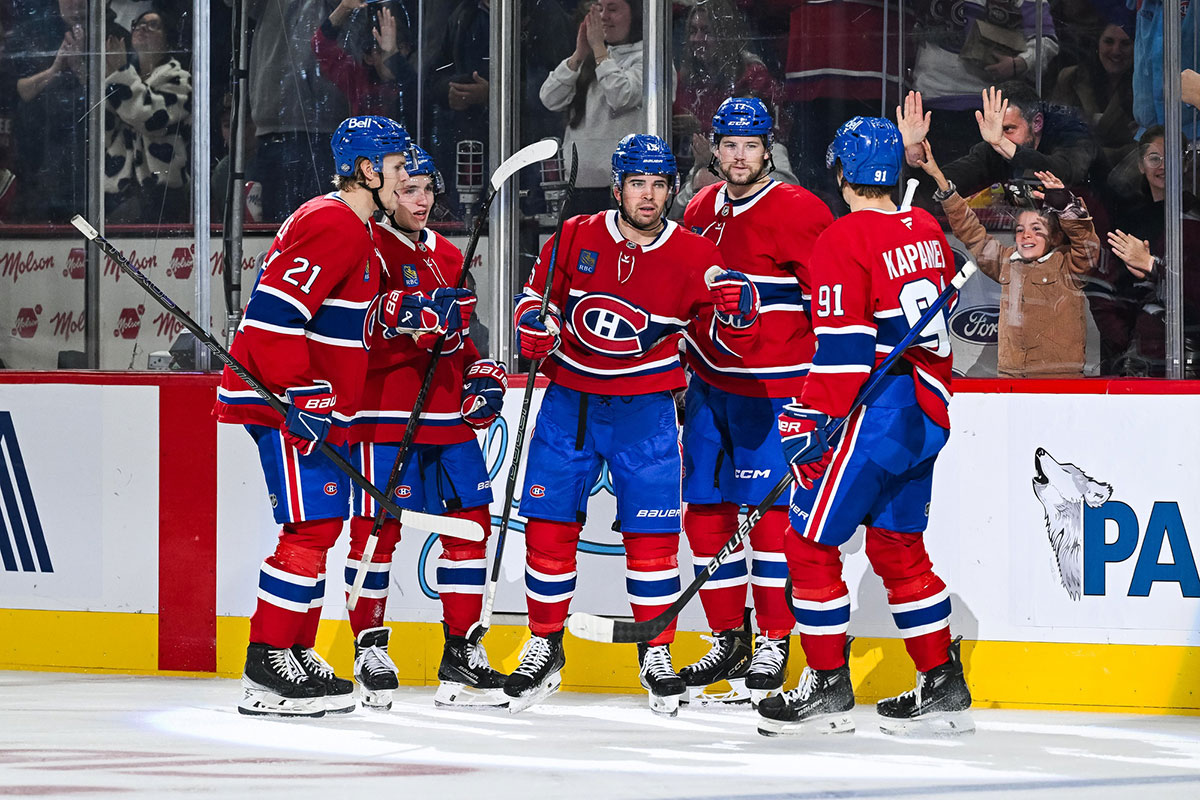 Montreal Canadiens center Alex Newhook (15) celebrates with defenseman Kaiden Guhle (21), defenseman Lane Hutson (48), right wing Josh Anderson (17) and center Oliver Kapanen (91) after scoring a goal against the Ottawa Senators during the third period at Bell Centre.