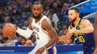 Los Angeles Lakers forward LeBron James (23) dribbles against Golden State Warriors guard Stephen Curry (30) during the first quarter at Chase Center.
