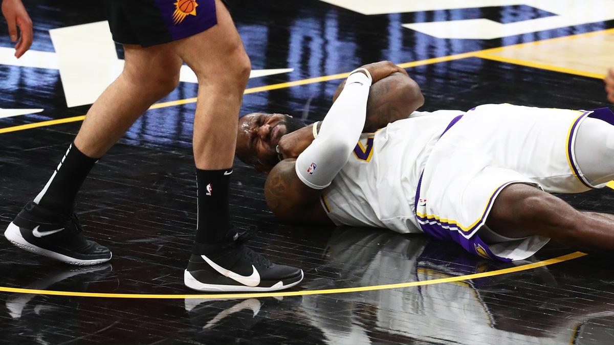 Los Angeles Lakers forward LeBron James reacts after suffering an injury against the Phoenix Suns in the second half during game one in the first round of the 2021 NBA Playoffs at Phoenix Suns Arena.