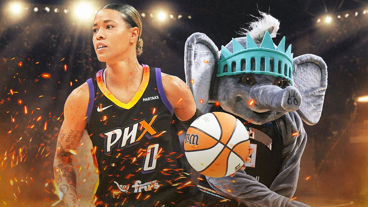 Action shot of Natasha Cloud on fire with New York Liberty mascot in the background