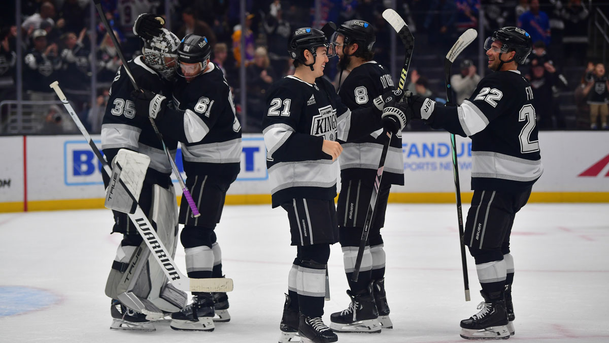 Los Angeles Kings goaltender Darcy Kuemper (35) center Trevor Lewis (61) defenseman Jordan Spence (21) defenseman Drew Doughty (8) and left wing Kevin Fiala (22) celebrate the victory against the New York Rangers at Crypto.com Arena.