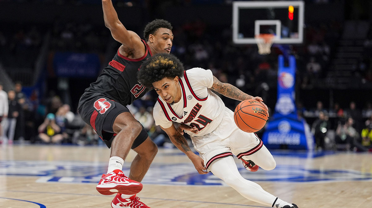 Louisville Cardinals guard Chucky Hepburn (24) tries to elude Stanford Cardinal guard Jaylen Blakes (21) during the second half at Spectrum Center.