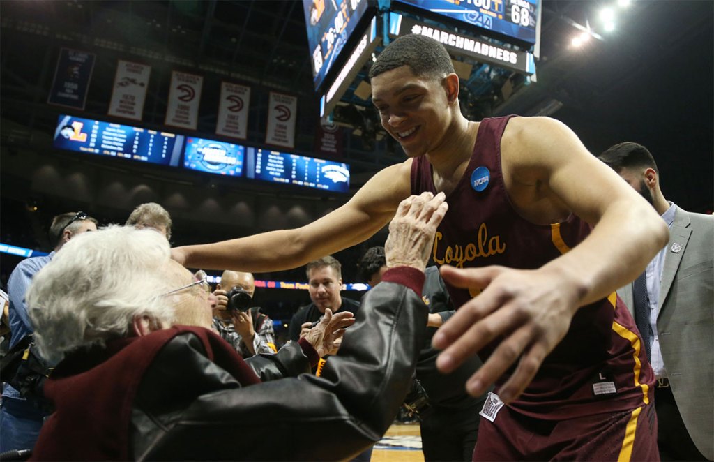 Loyola Ramblers guard Lucas Williamson (1) hugs Sister Jean Dolores-Schmidt after defeating the Nevada Wolf Pack in the semifinals of the South regional of the 2018 NCAA Tournament at Philips Arena.