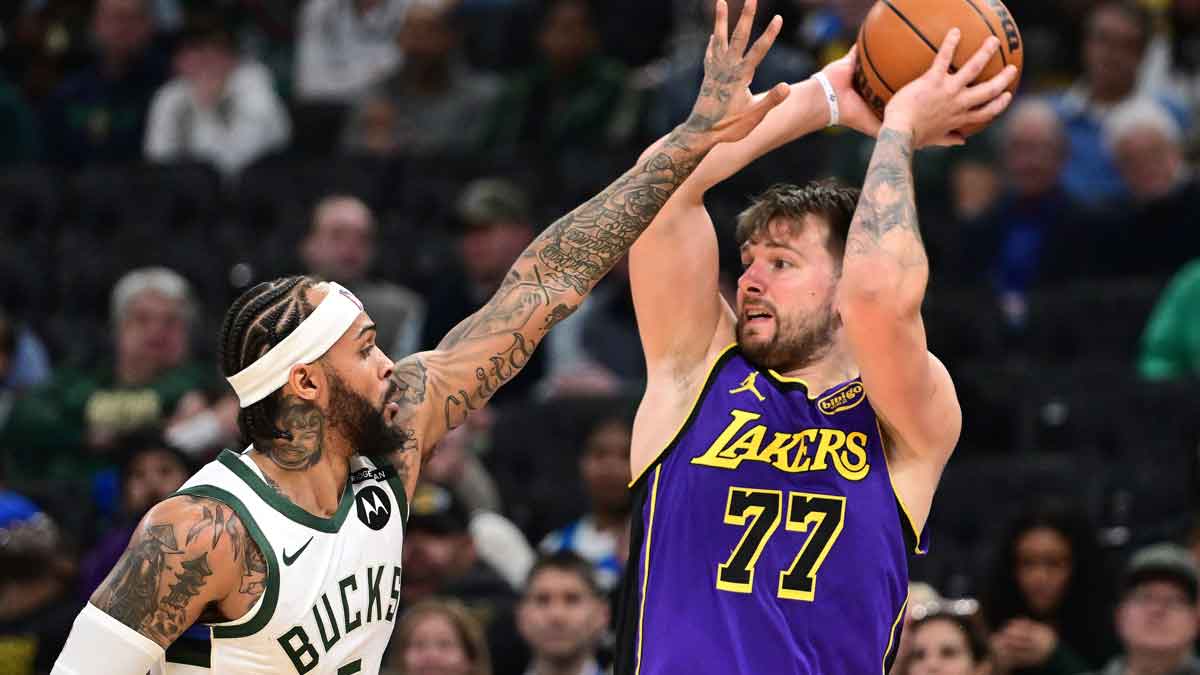 Milwaukee Bucks guard Gary Trent Jr. (5) defends Los Angeles Lakers guard Luka Doncic (77) in the fourth quarter at Fiserv Forum.