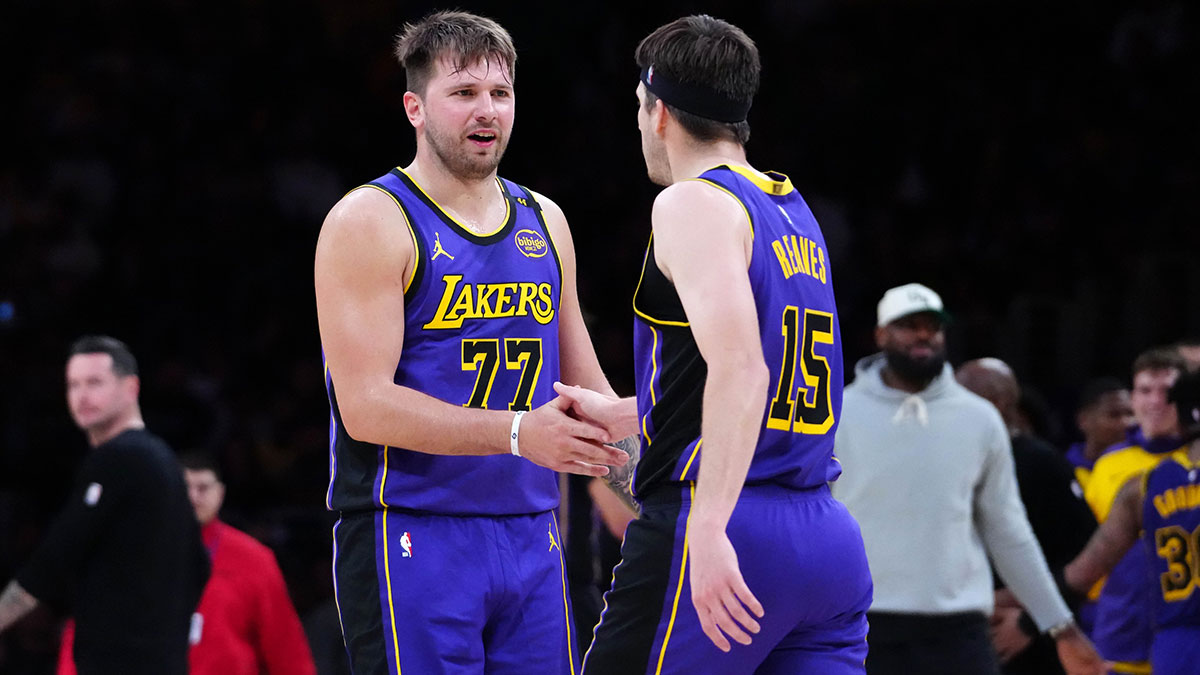 Los Angeles Lakers Guard Luka Doncic (77) and guard Austin Reautive (15) react to San Antonio Spurs in the first half at the Cripto.com Arena. 