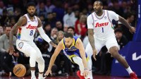 Golden State Warriors guard Stephen Curry (30) looses control of the ball in front of Philadelphia 76ers forward Paul George (8) and center Andre Drummond (1) during the first quarter at Wells Fargo Center.