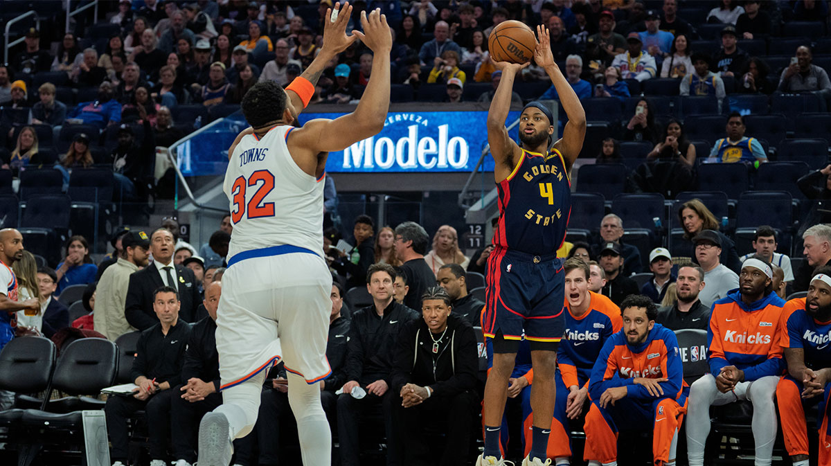 Golden State Warriors guard Moses Moody (4) shoots a three point shot against New York Knicks center Karl-Anthony Towns (32) during the third quarter at Chase Center.