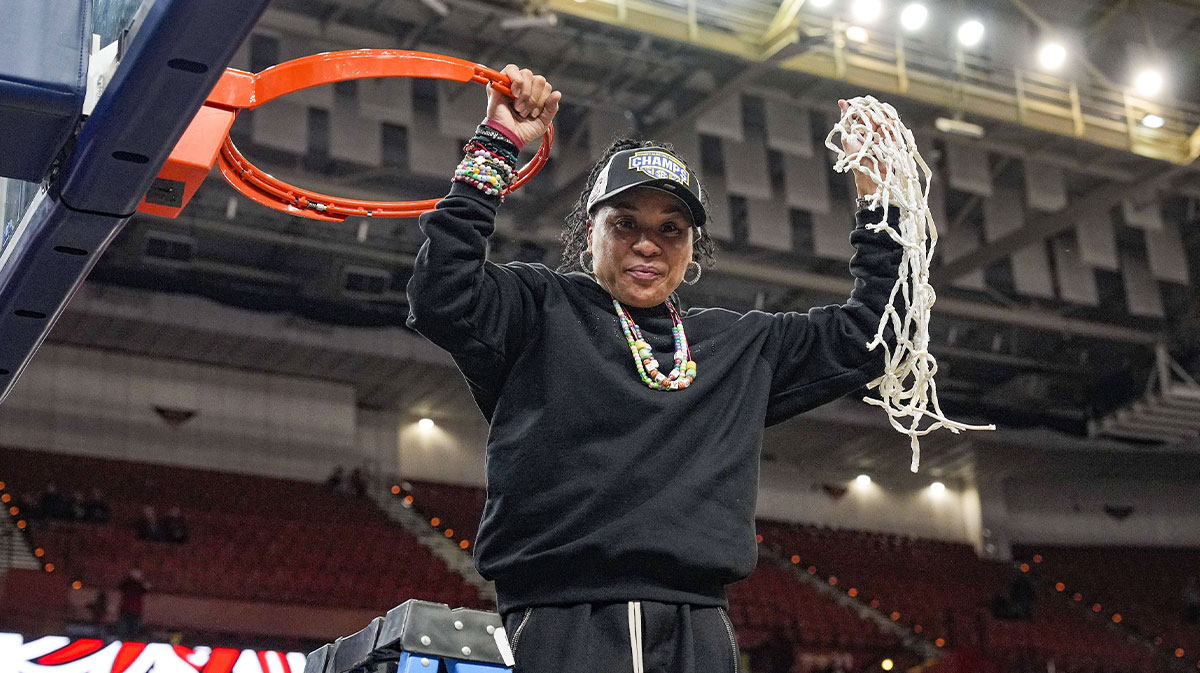 South Carolina Gamecocks head coach Dawn Staley cuts the net down after the win over Texas in the SEC womenís championship at Bon Secours Wellness Arena.