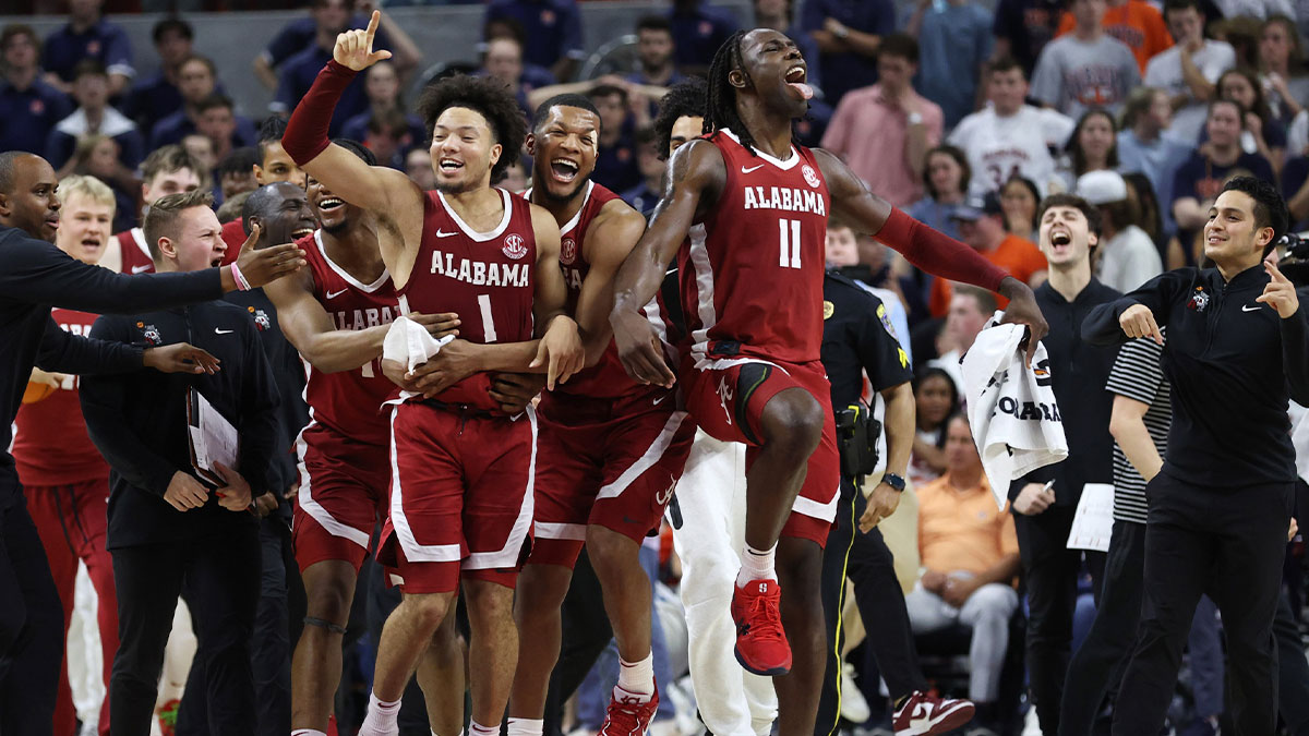 Alabama Crimson Tide guard Mark Sears (1) celebrates with teammates after making the game winning shot to beat the Auburn Tigers in overtime at Neville Arena.