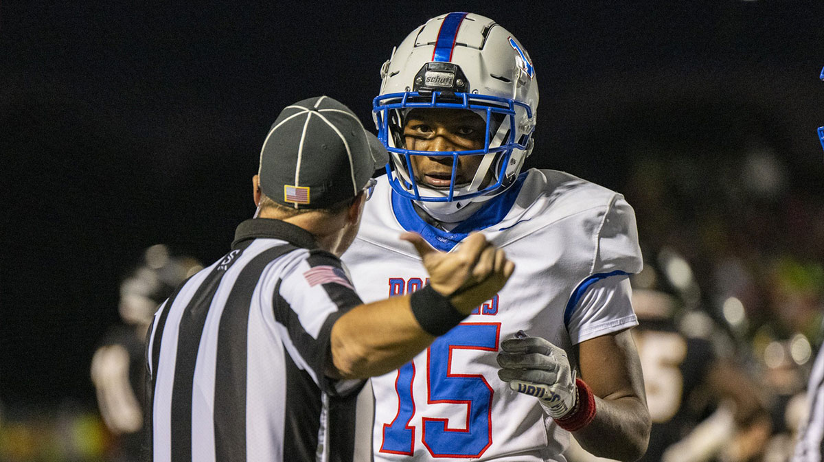 A game official warns Hamilton Southeastern High School senior Mason Alexander (15) after already receiving a personal foul penalty earlier during the second half of an IHSAA varsity football game against Avon High School, Friday, Sept. 6, 2024, at Avon High School.