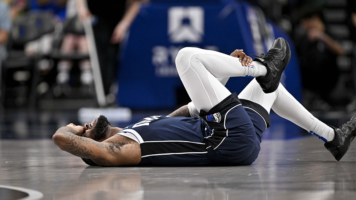 Dallas Mavericks guard Jaden Hardy (1) grabs his leg after suffering an apparent injury during the second half against the Sacramento Kings at the American Airlines Center.