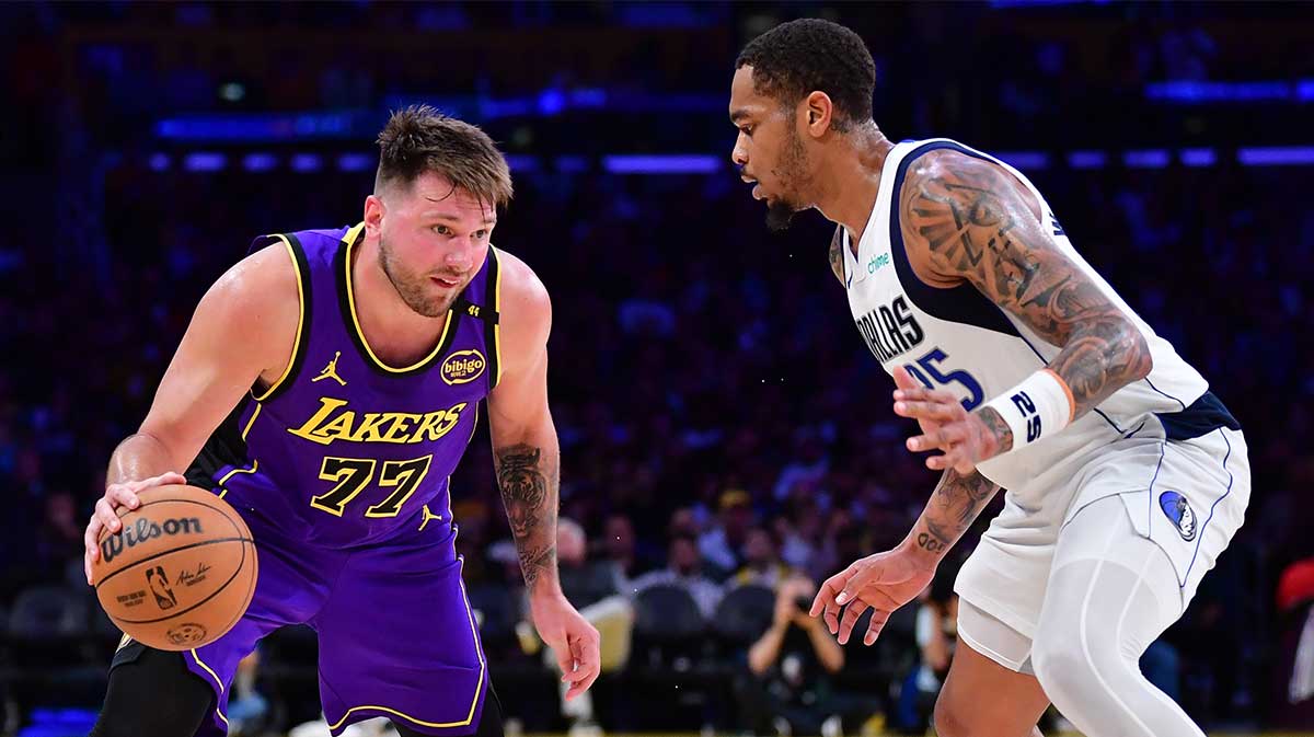 Lakers guard Luka Doncic (77) dribbles the ball against Dallas Mavericks forward P.J. Washington (25) during the second half at Crypto.com Arena