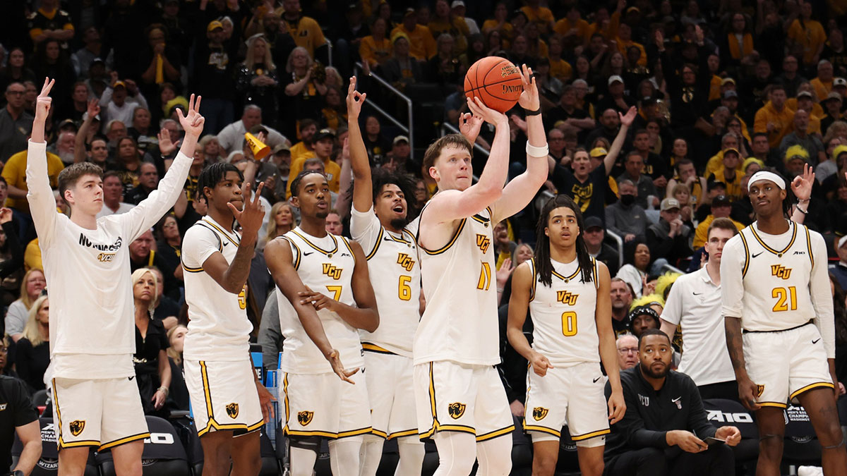 VCU Rams guard Max Shulga (11) shoots the ball in front of his bench against the George Mason Patriots in the second half at Capital One Arena.