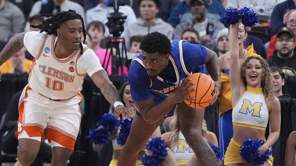 Mar 20, 2025; Providence, RI, USA; McNeese State Cowboys guard Brandon Murray (23) grabs a rebound against Clemson Tigers guard Del Jones (10) during the first half at Amica Mutual Pavilion. Mandatory Credit: Gregory Fisher-Imagn Images