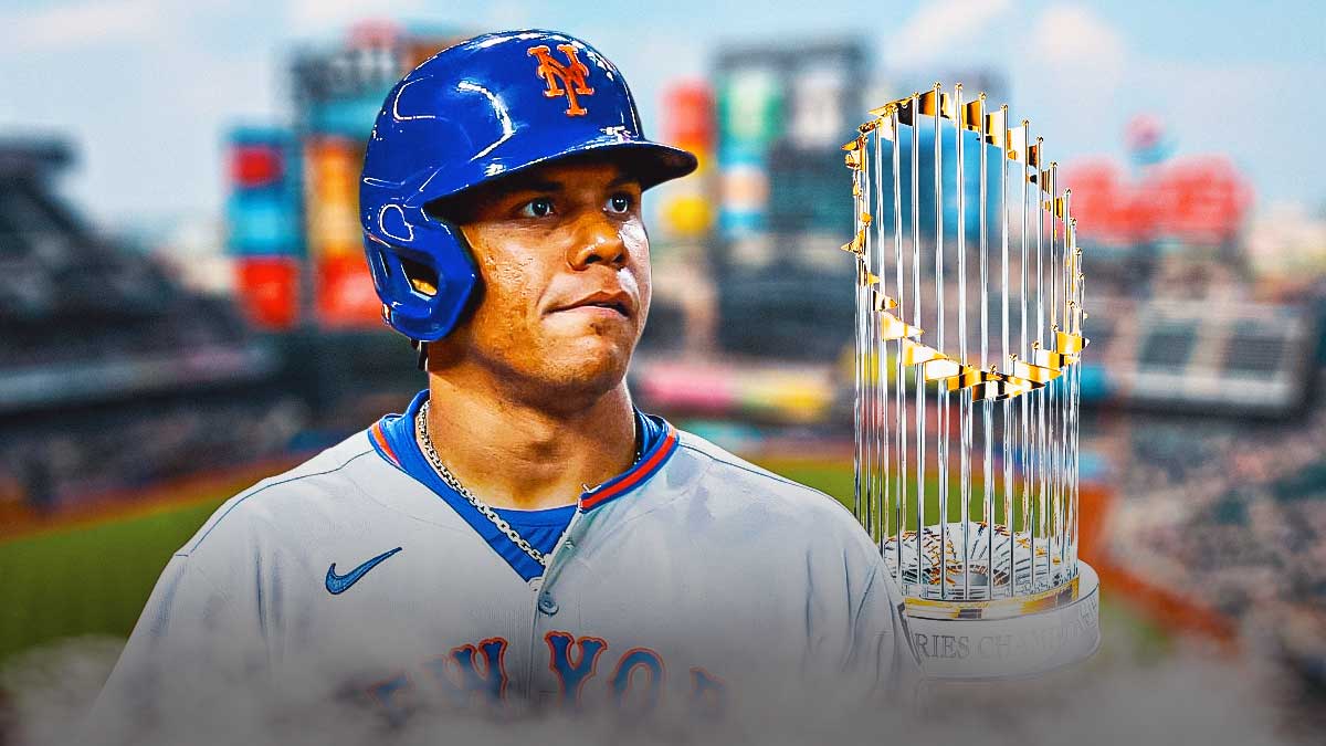 Juan Soto in a New York Mets uniform with a World Series trophy next to him