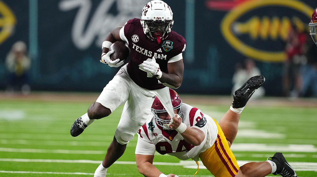 Texas A&M Aggies wide receiver Micah Tease (4) carries the ball against Southern California Trojans defensive tackle Kobe Pepe (94) in the second half at Allegiant Stadium. Mandatory Credit: Kirby Lee-Imagn Images
