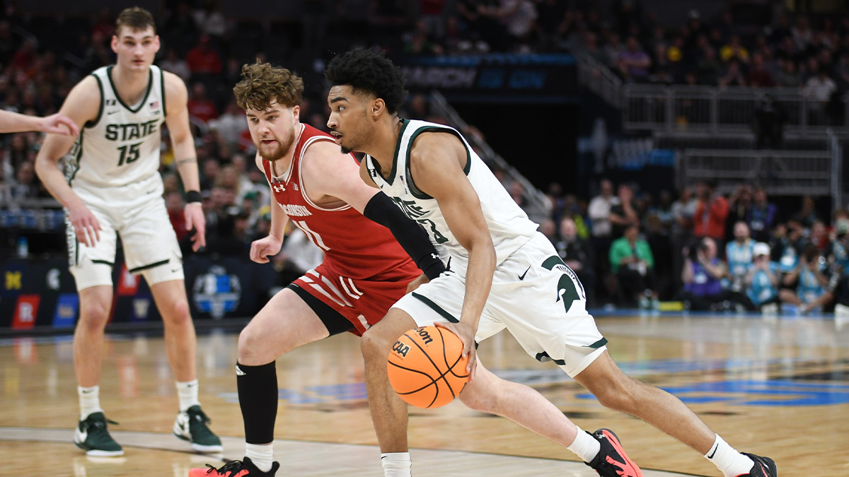 Michigan State Spartans guard Jaden Akins (3) goes to the basket against Wisconsin Badgers guard Max Klesmit (11) during the second half at Gainbridge Fieldhouse. Mandatory Credit: Robert Goddin-Imagn Images