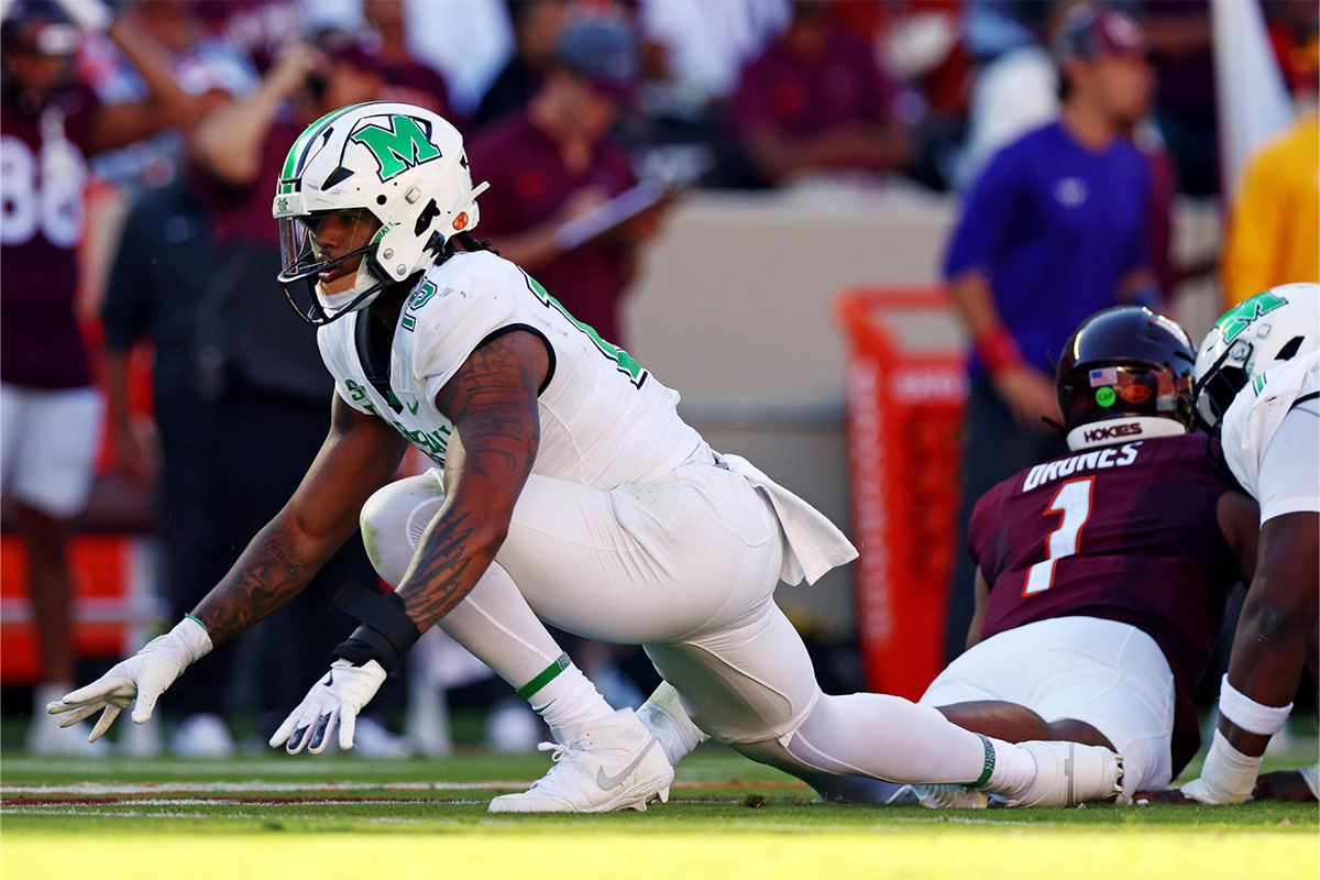 Marshall Thundering Herd defensive lineman Mike Green (15) celebrates after sacking Virginia Tech Hokies quarterback Kyron Drones (1) during the first quarter at Lane Stadium