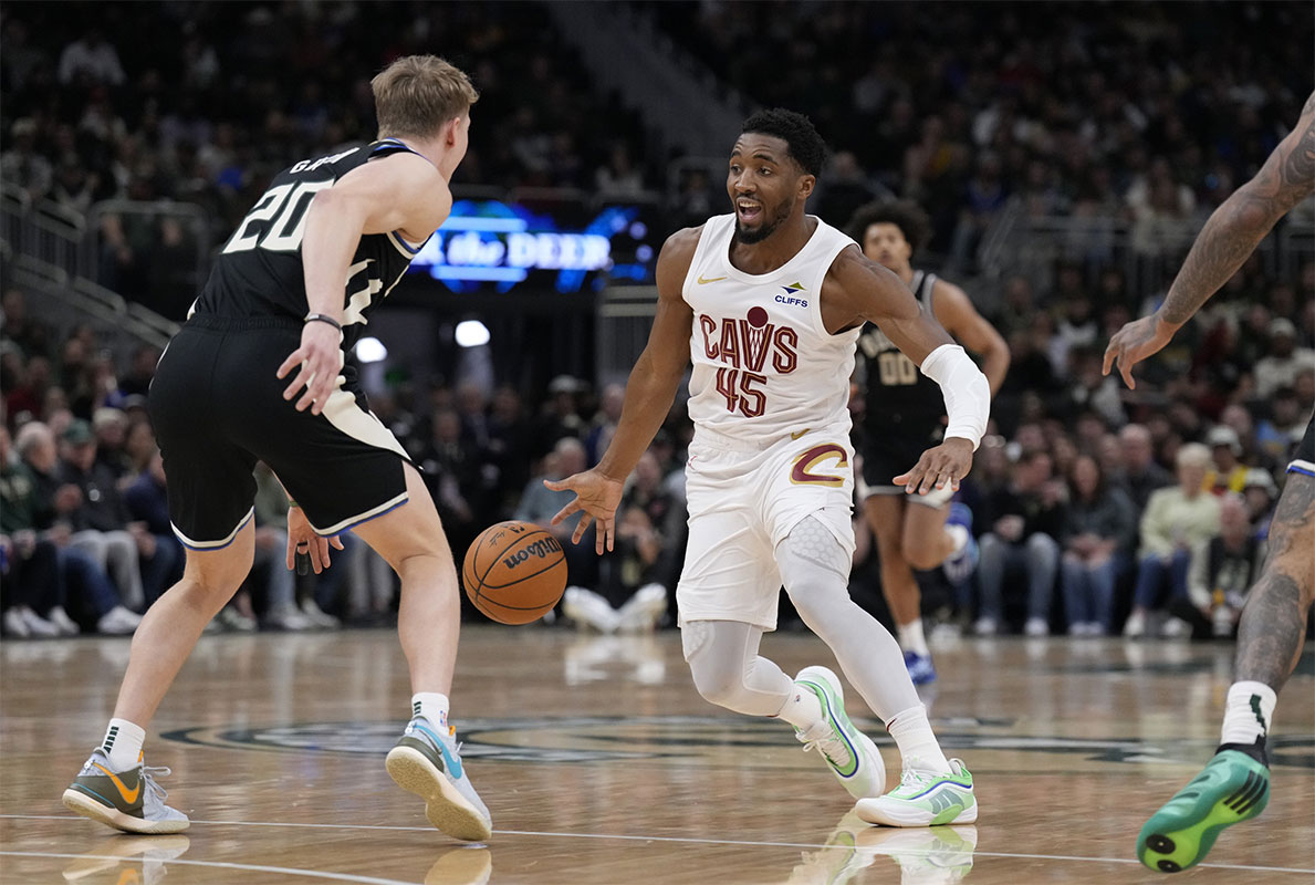 Cleveland Cavaliers Guard Donovan Mitchell (45) Drive against Milvaukee Buck Guard AJ Green (20) In the first half at Fiserv Forum