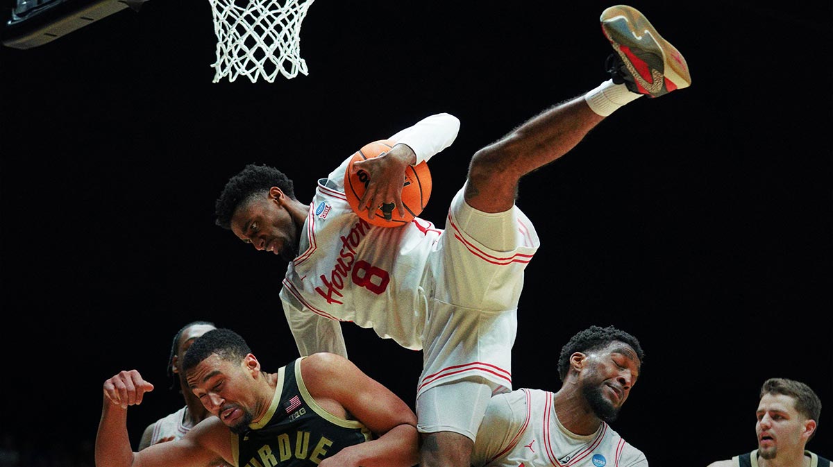 Houston Cougars guard Mylik Wilson (8) grabs a rebound against Purdue Boilermakers forward Trey Kaufman-Renn (4) in the second half during a Midwest Regional semifinal of the 2025 NCAA tournament at Lucas Oil Stadium.