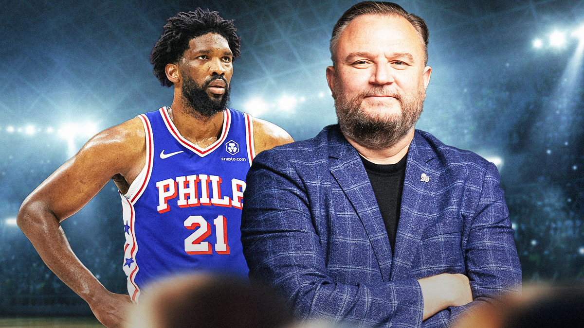 76ers center Joel Embiid next to 76ers' president Daryl Morey with the Philadelphia skyline in the background