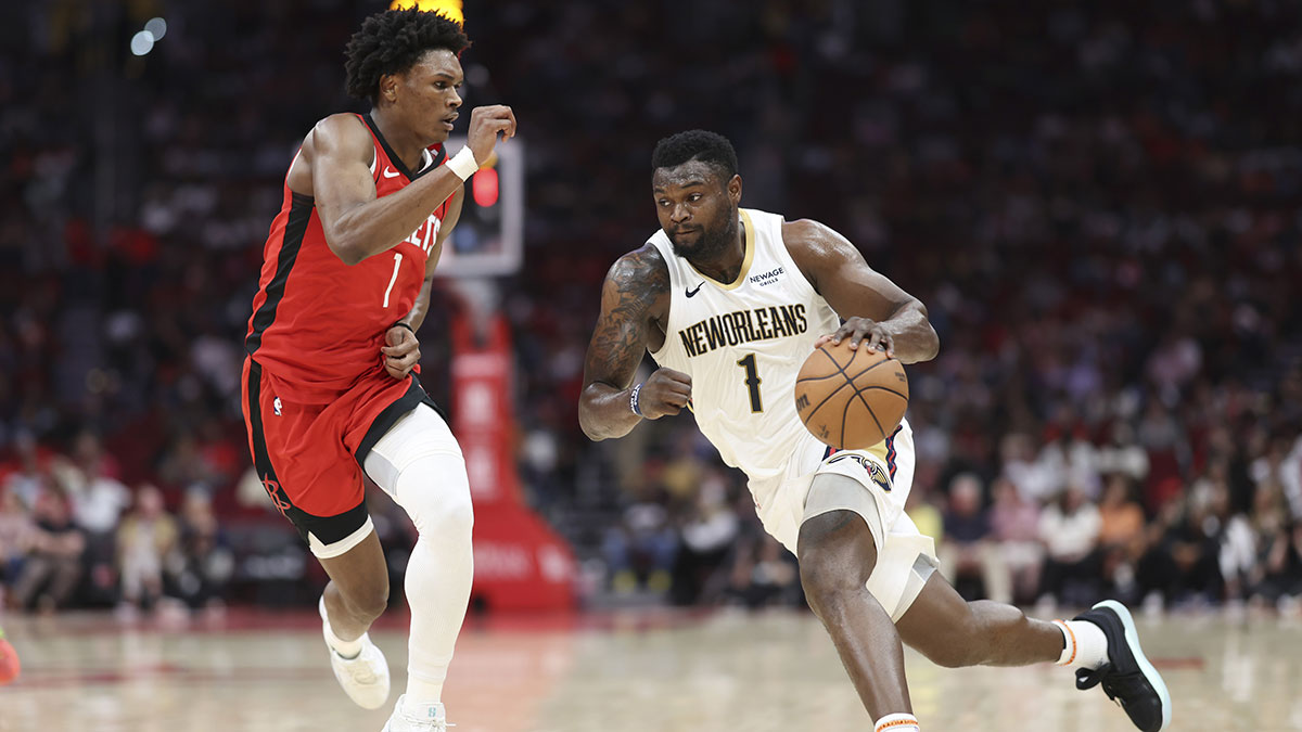 New Orleans Pelicans forward front Williamson (1) Dreamlible Ball as Houston Rockets Next Amen Thompson (1) Defend during the game in Toyota Center.