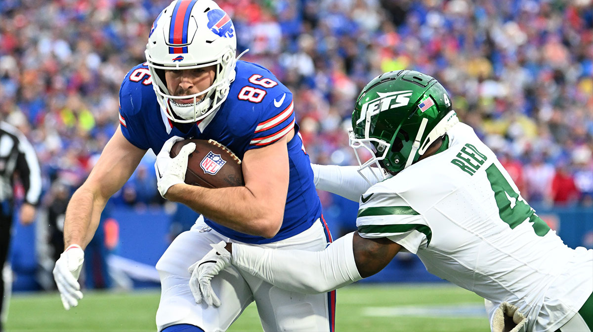 Buffalo Bills tight end Dalton Kincaid (86) tries to break free from New York Jets cornerback D.J. Reed (4) after a catch in the first quarter at Highmark Stadium.