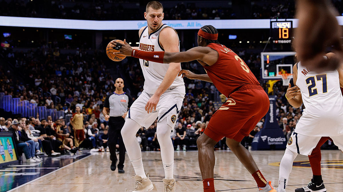 Denver Nuggets Center Nikola Jokic (15) control the ball like Cleveland Cavaliers Guard Caris Levert (3) Guards in the fourth quarter quarter.