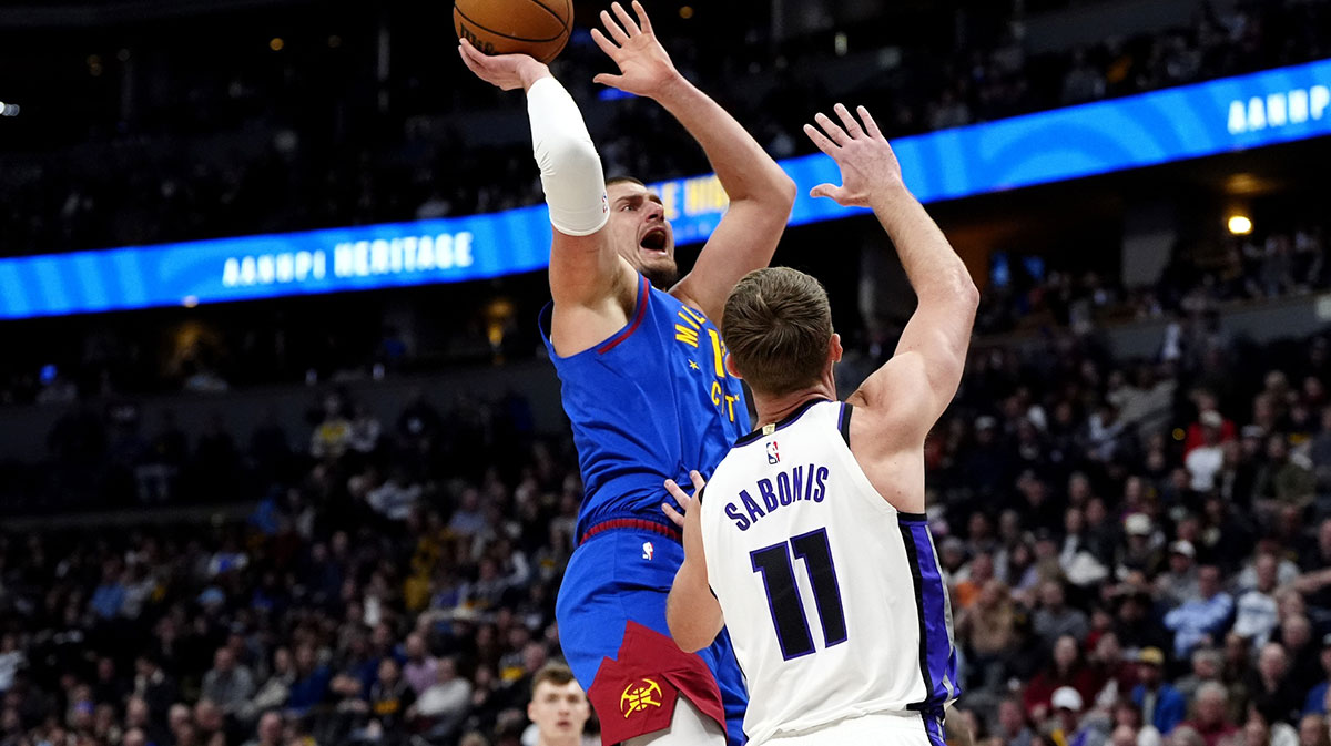 Denver Nuggets Center Nikola Jokić (15) shoots at Sacramento Kings forwards domantas Sabonis (11) in the first quarter at the ballley Arena.