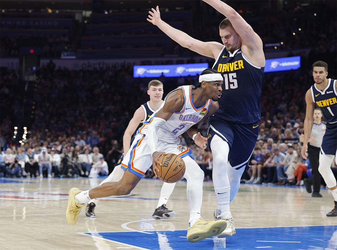 Oklahoma City Thunder Guard Shai Gilgeous-Alexander (2) Drive against Denver Nugget Center Nikola Jokic (15) during the second half in the center of Paicom. 