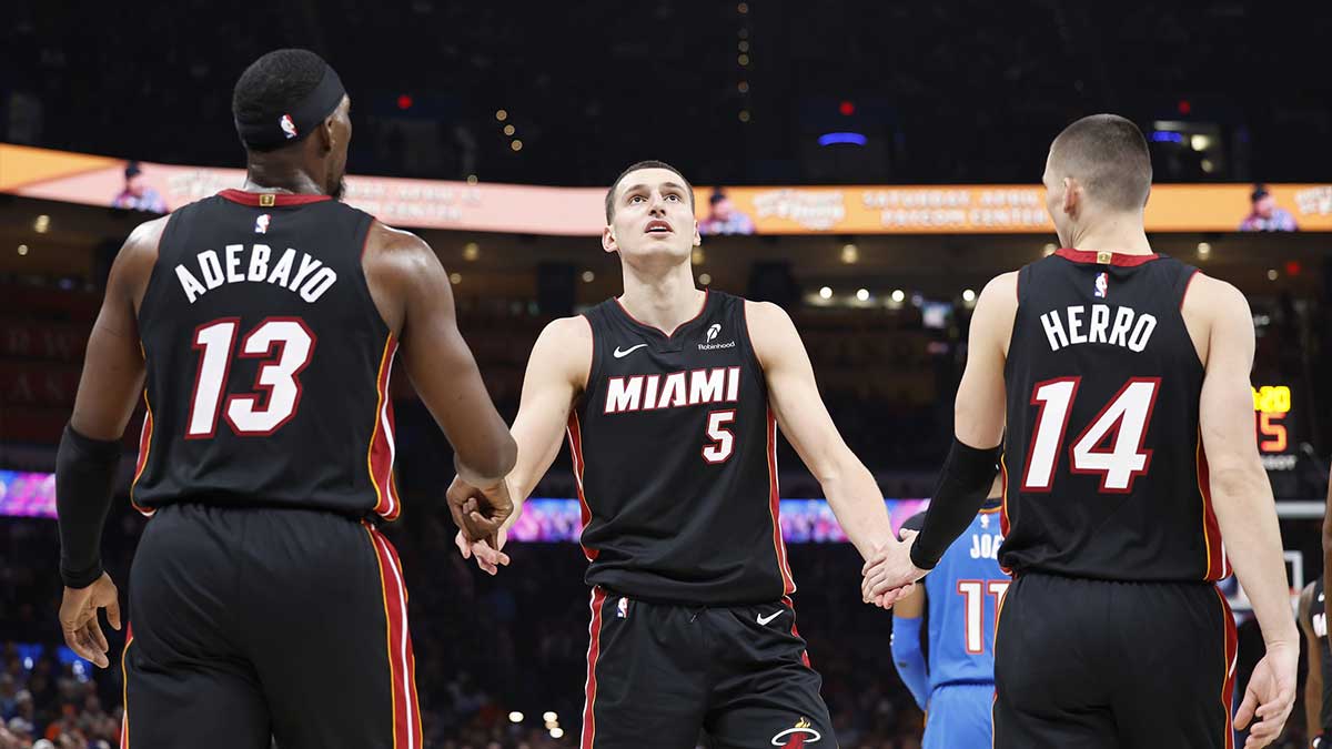 Miami Heat forward Nikola Jovic (5) celebrates with teammates center Bam Adebayo (13) and guard Tyler Herro (14) after a play against the Oklahoma City Thunder during the second quarter at Paycom Center.