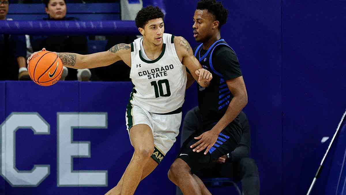 Colorado State Rams guard Nique Clifford (10) controls the ball as Air Force Falcons guard Ethan Taylor (5) guards in the second half at Clune Arena.