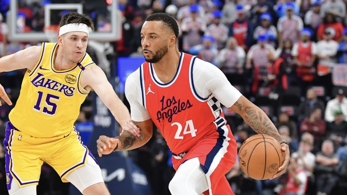 Los Angeles Clippers guard Norman Powell (24) moves the ball against Los Angeles Lakers guard Austin Reaves (15) during the first half at Intuit Dome.