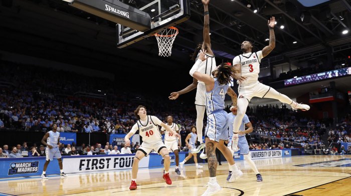 North Carolina Tar Heels guard RJ Davis (4) shoots the ball over San Diego State Aztecs forward Pharaoh Compton (5) and guard Wayne McKinney III (3) in the second half at UD Arena.