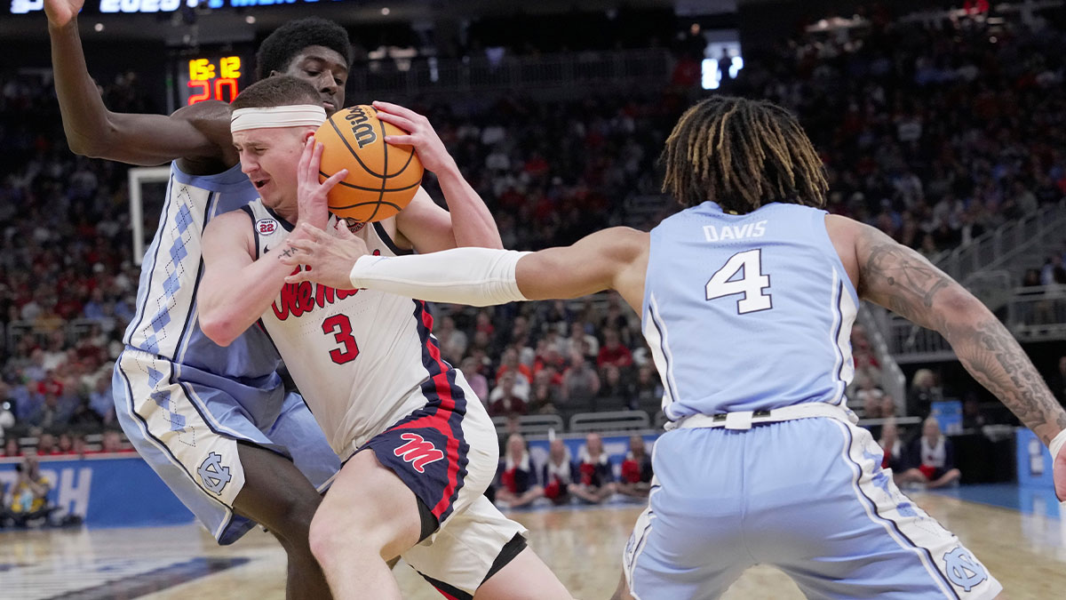 Mississippi guard Sean Pedulla (3) drives between North Carolina guard Cade Tyson (5) and guard RJ Davis (4) during the first half of their first round NCAA tournament game Friday at Fiserv Forum