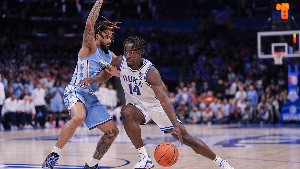 Duke Blue Devils guard Sion James (14) handles the ball against North Carolina Tar Heels guard RJ Davis (4) during the second half at Spectrum Center. Mandatory Credit: Jim Dedmon-Imagn Images