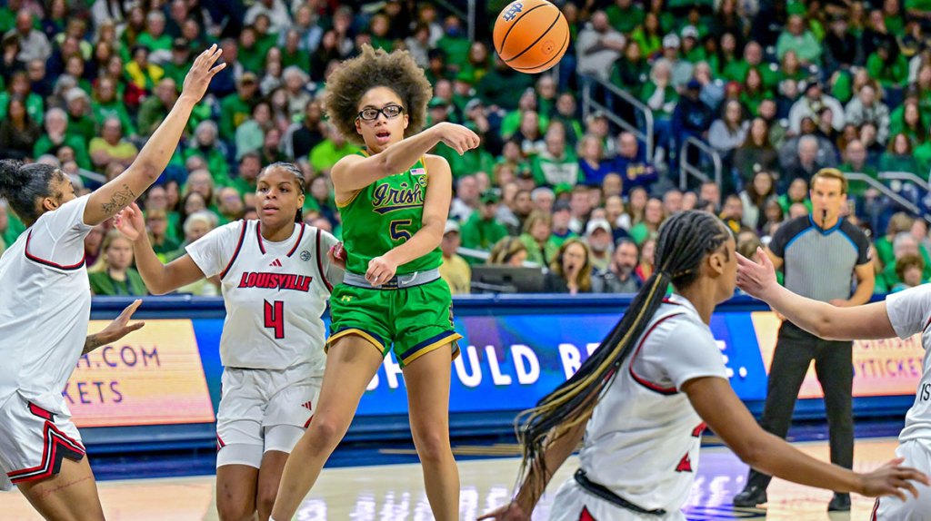 Notre Dame Fighting Irish guard Olivia Miles (5) passes asLouisville Cardinals forward Mackenly Randolph (4) defends in the second half,