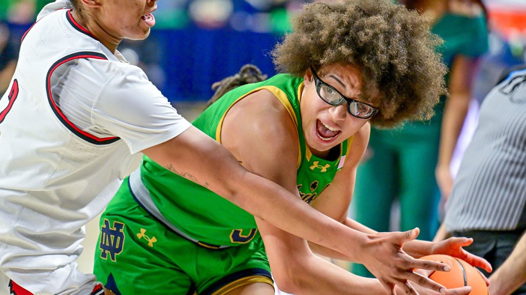 Notre Dame Fighting Irish guard Olivia Miles (5) looks to pass as Louisville Cardinals forward Nyla Harris (2) defends in the second half.