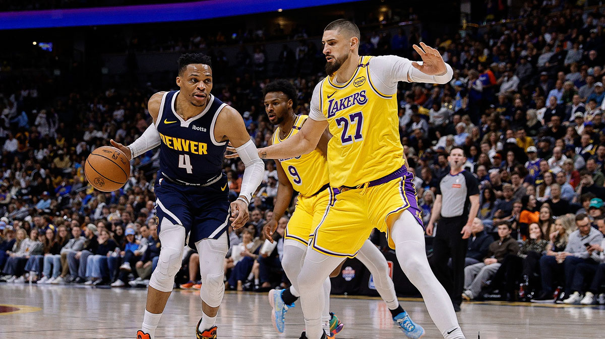 Denver Nuggets guard Russell Westbrook (4) controls the ball as Los Angeles Lakers center Alex Len (27) guards in the second quarter at Ball Arena.