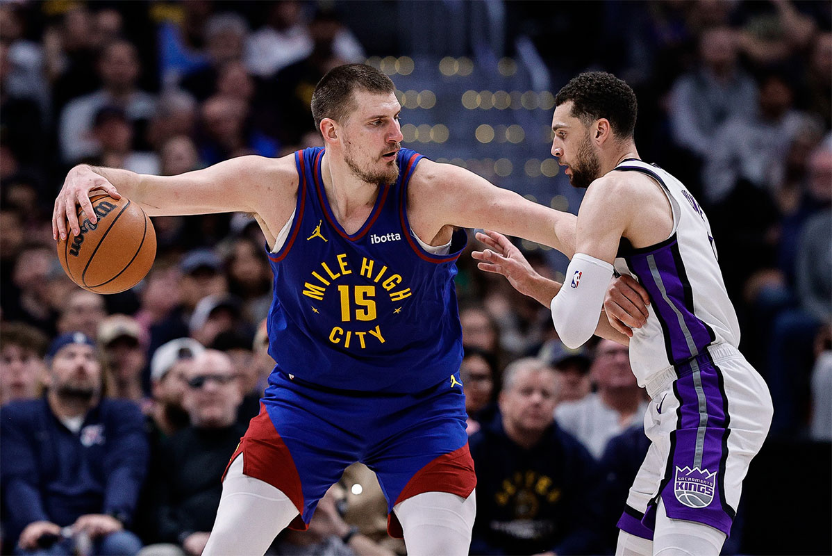 Nuggets center Nikola Jokic (15) controls the ball as Sacramento Kings guard Zach LaVine (8) guards in the fourth quarter at Ball Arena