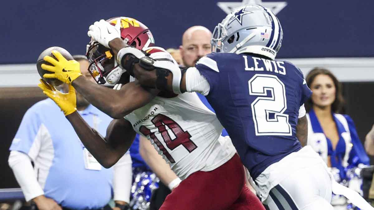 Washington Commanders wide receiver Olamide Zaccheaus (14) makes a catch over Dallas Cowboys cornerback Jourdan Lewis (2) during the second half at AT&T Stadium. Mandatory Credit: Kevin Jairaj-Imagn Images
