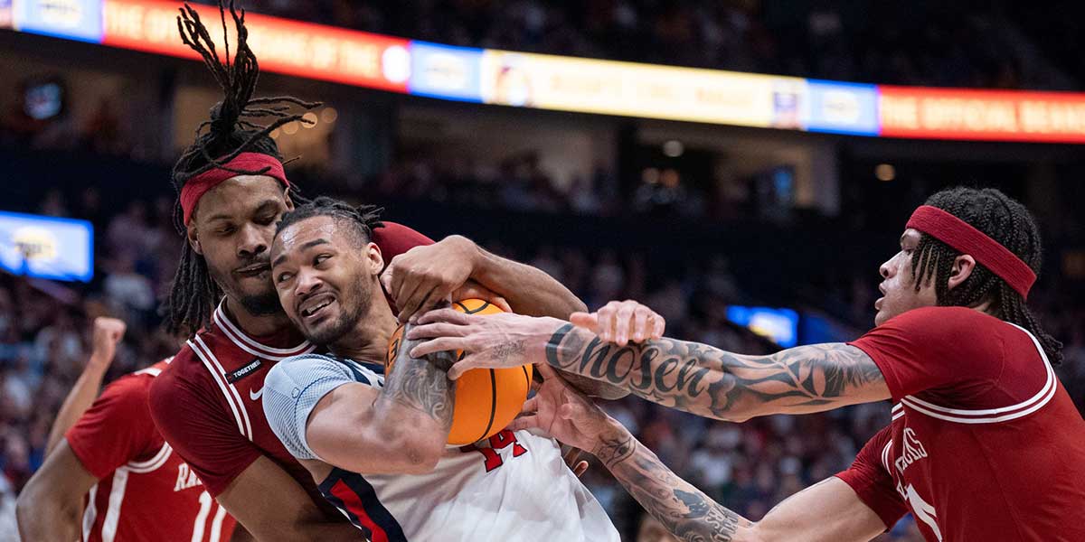 Arkansas Razorbacks forward Jonas Aidoo (9) guards Mississippi Rebels guard Dre Davis (14) while Arkansas Razorbacks guard Ayden Kelley (14) defends during their second round game of the SEC Men's Basketball Tournament at Bridgestone Arena in Nashville, Tenn., Thursday, March 13, 2025.