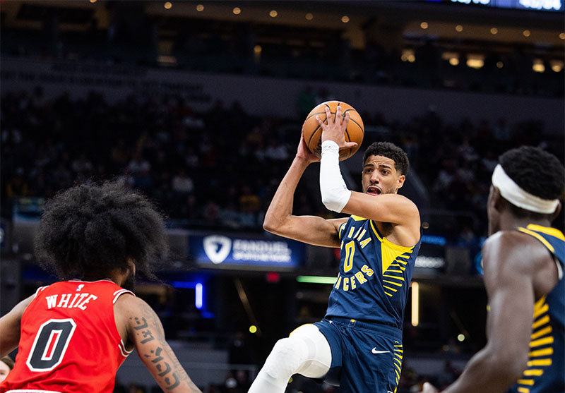 Indiana Pacers guard Tyrese Haliburton (0) shoots the ball while Chicago Bulls guard Coby White (0) defends in the second half at Gainbridge Fieldhouse.